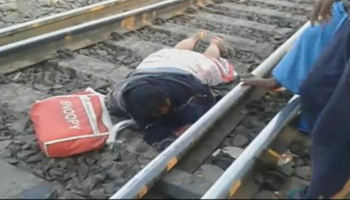 Woman Escapes Unhurt As Train Passes over Her