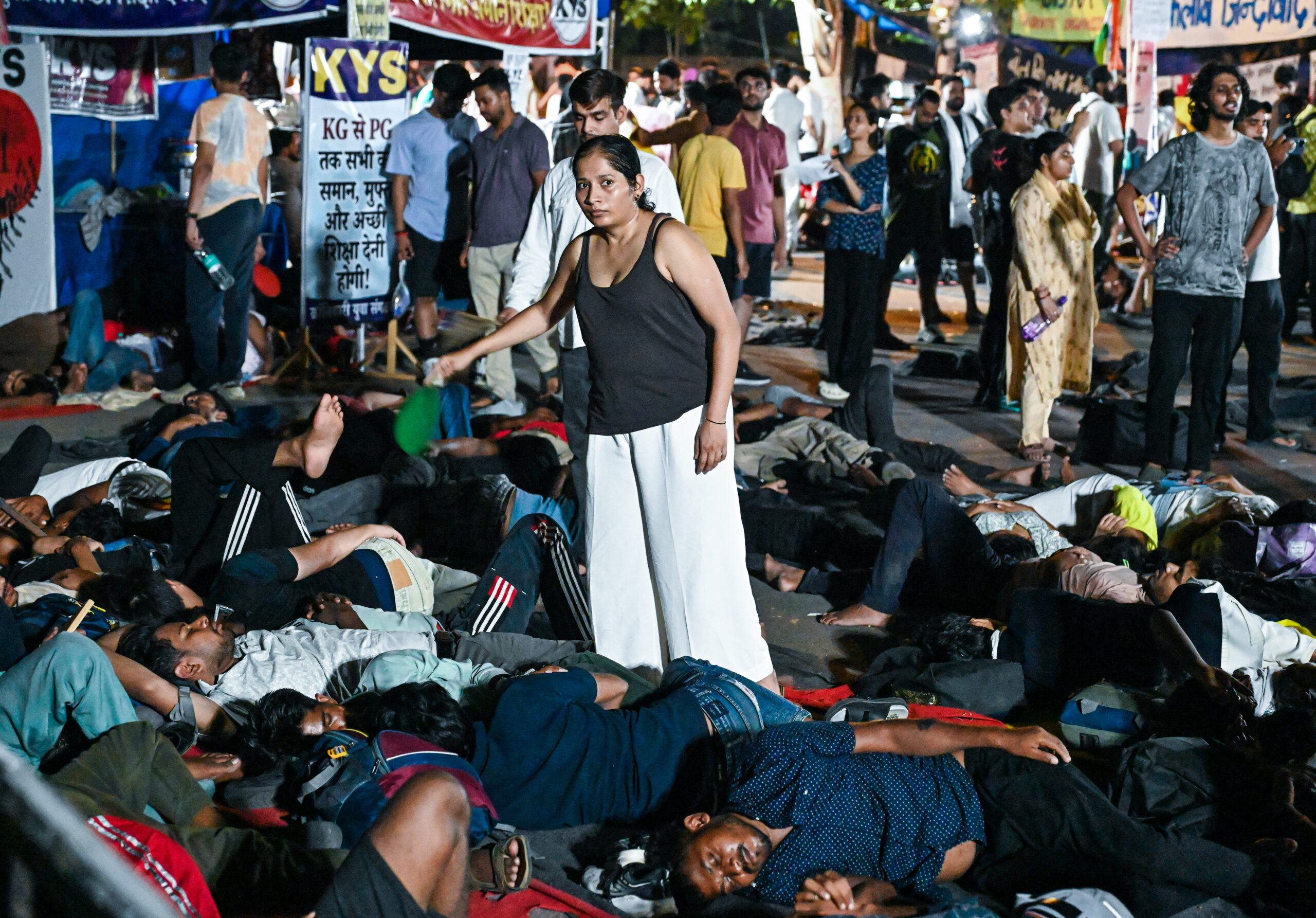 New Delhi: Supporters of Cockroach Janta Party (CJP) rest overnight at Jantar Mantar during the ongoing protest demanding the resignation of Union Education Minister Dharmendra Pradhan over alleged examination irregularities in New Delhi on Saturday night, July 18, 2026. (Photo: IANS/Deepak Kumar)