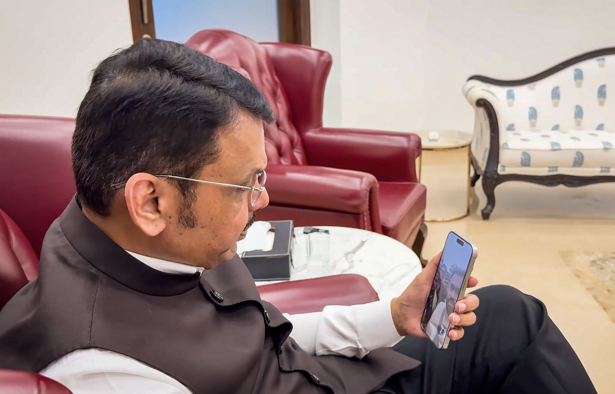 Mumbai: Maharashtra Chief Minister Devendra Fadnavis interacts with tourists from Maharashtra stranded in flood-hit Nepal through a video call and assures them of government support for their safe return, on Thursday, August 27, 2026. (Photo: IANS/Video Grab)