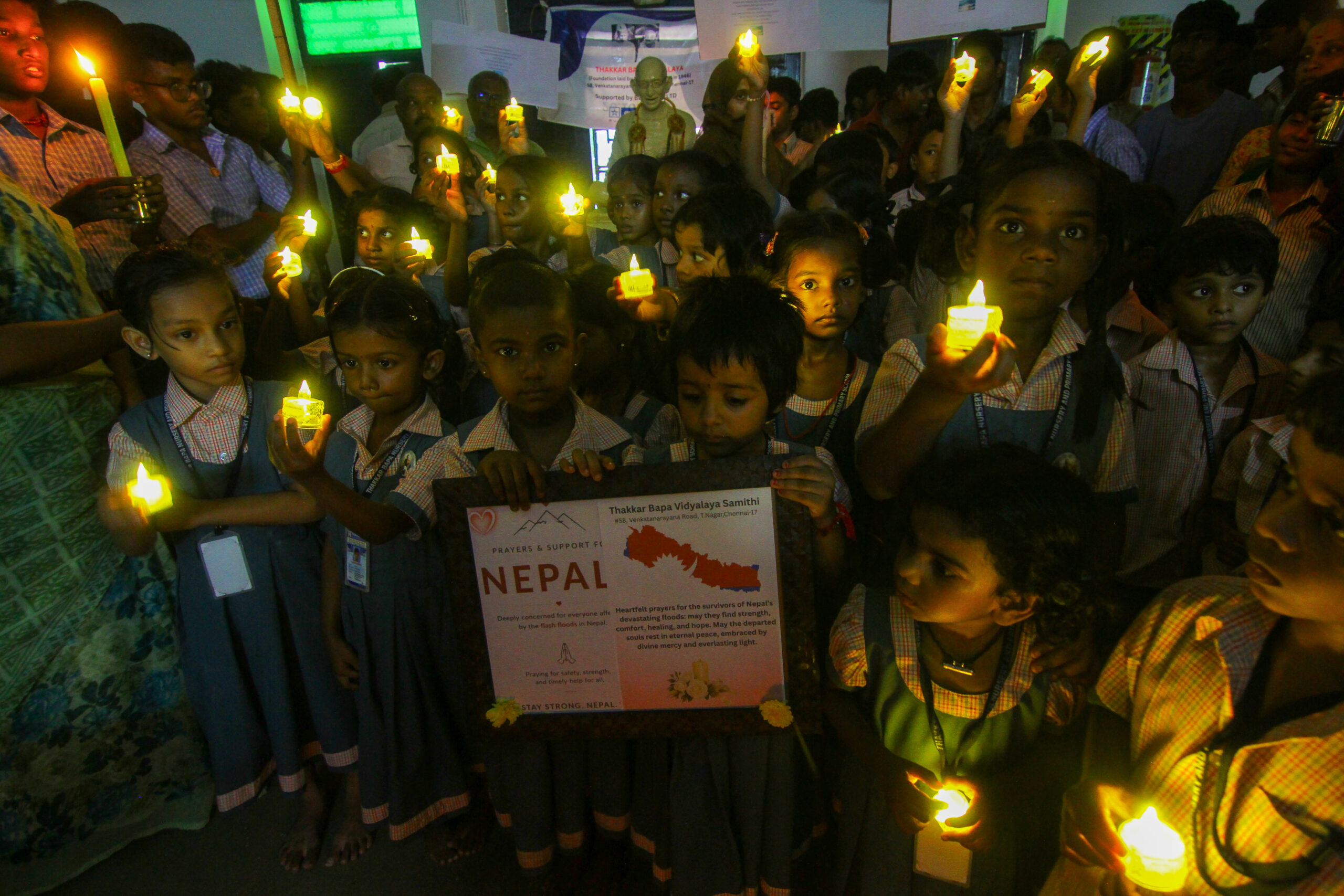 Chennai: School students hold candles as they gather to pay homage to those who lost their lives in the flash floods in Nepal, in Chennai on Friday, August 28, 2026. (Photo: IANS)