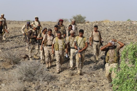 The picture taken on March 12, 2021 shows soldiers of the Yemeni government marching forward as they are launching an offensive against the Houthi rebels in Abs district, Hajjah Province, north Yemen. (Photo by Mohammed al-Wafi)
