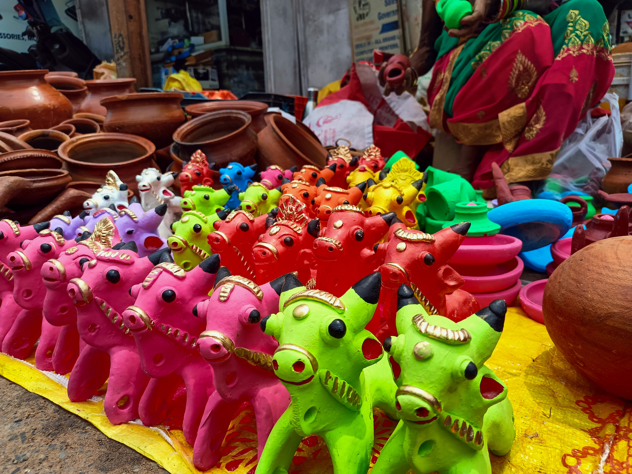 Bastar: A woman sells clay bulls and traditional toys on a roadside pavement ahead of the Pola festival at Gol Bazaar in Jagdalpur, Bastar district, on  Wednesday, September 9, 2026. (Photo: IANS)