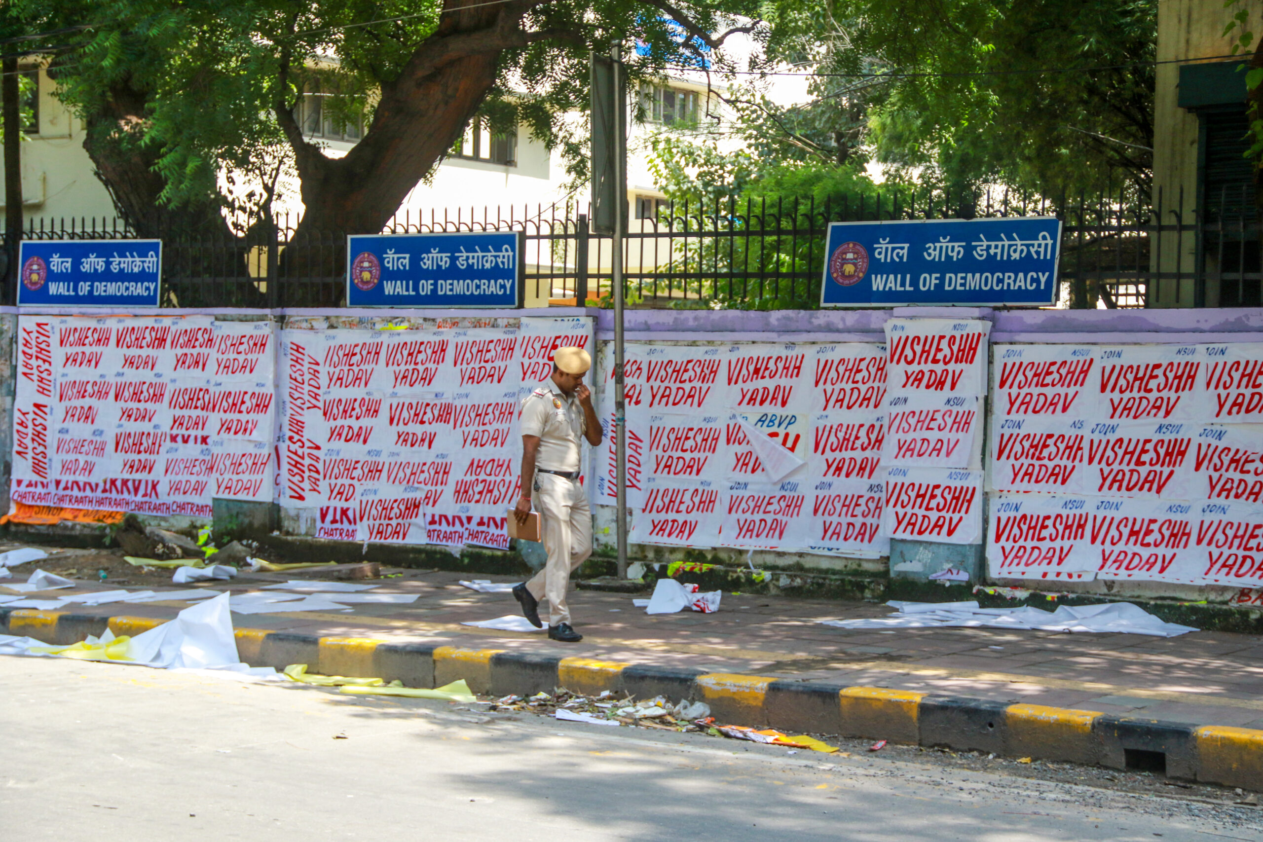 New Delhi: A police personnel walks past the 'Wall of Democracy' covered with election posters ahead of the Delhi University Students' Union (DUSU) elections, at North Campus, in New Delhi on Wednesday, September 9, 2026. (Photo: IANS/Qamar Sibtain)