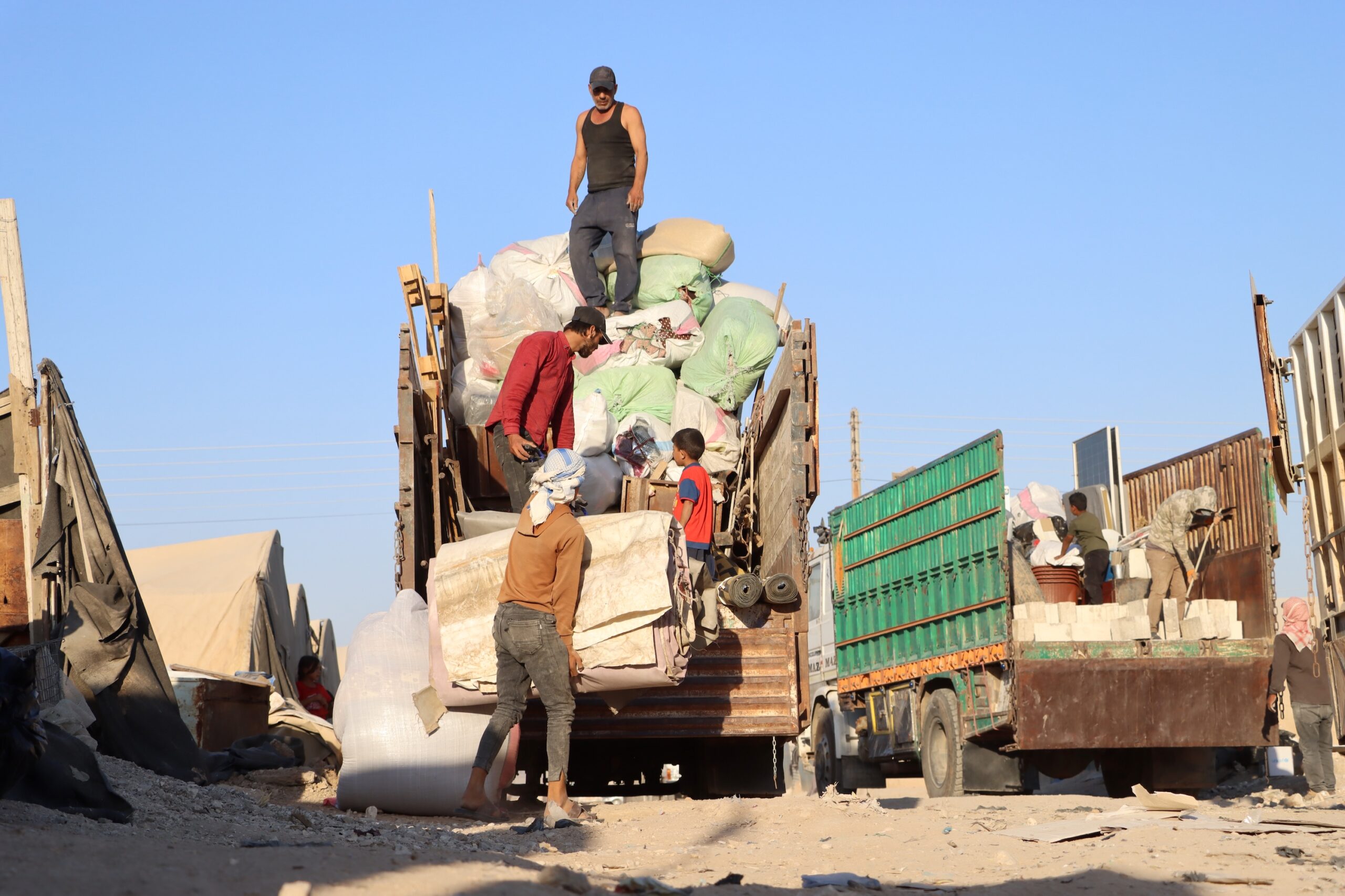 Hasakah: People load household belongings onto trucks as displaced families prepare to return to Ras al-Ain and its countryside from a camp in Syria's northeastern Hasakah province, Sept. 7, 2026. TO GO WITH "Feature: After years of displacement, Syrian families take their tents home" (Photo: Xinhua via IANS)