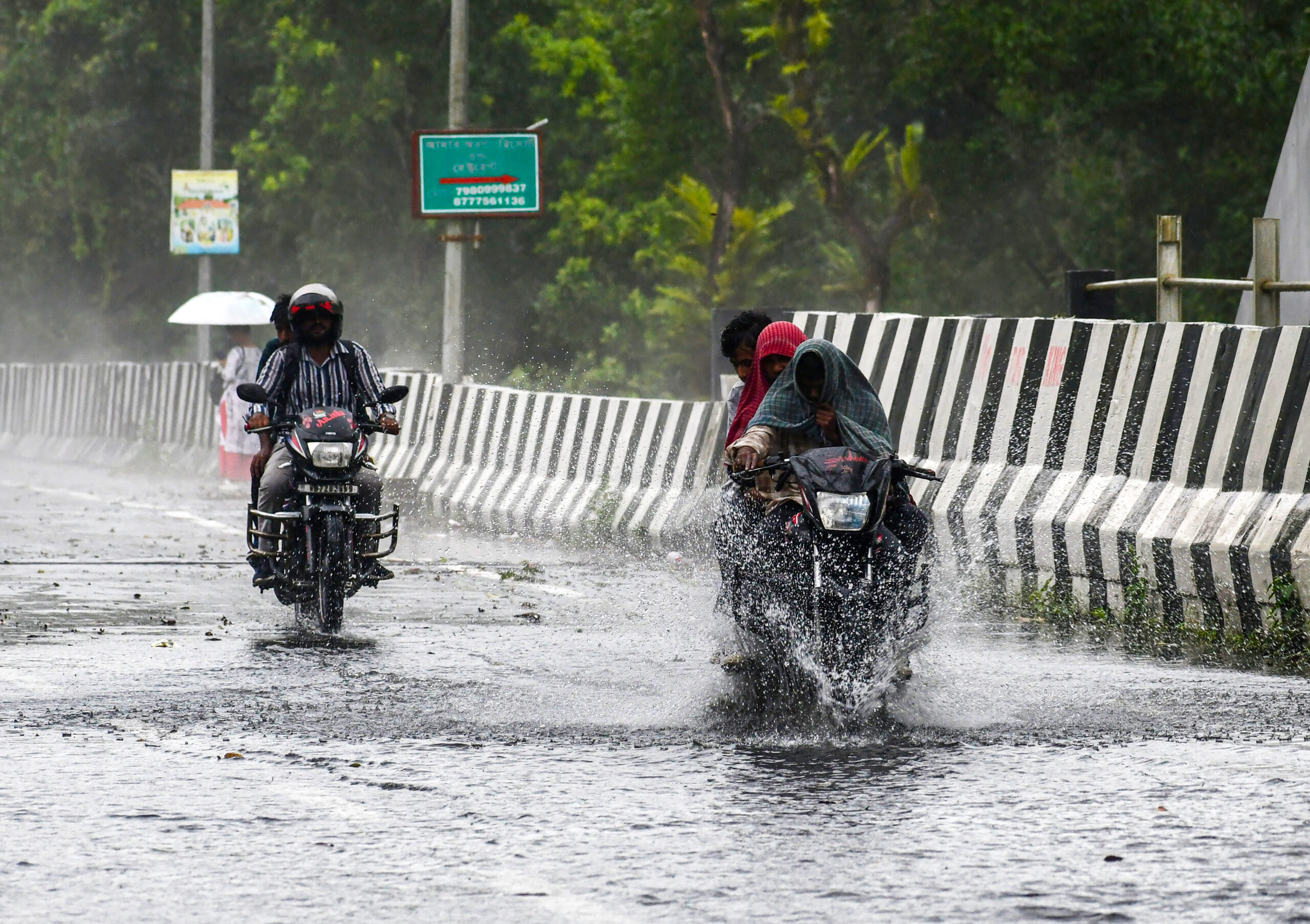 Jalpaiguri: People ride two-wheelers through a waterlogged stretch of a flyover on the national highway in Lataguri, Jalpaiguri district, West Bengal, on Thursday, September 10, 2026. (Photo: IANS)