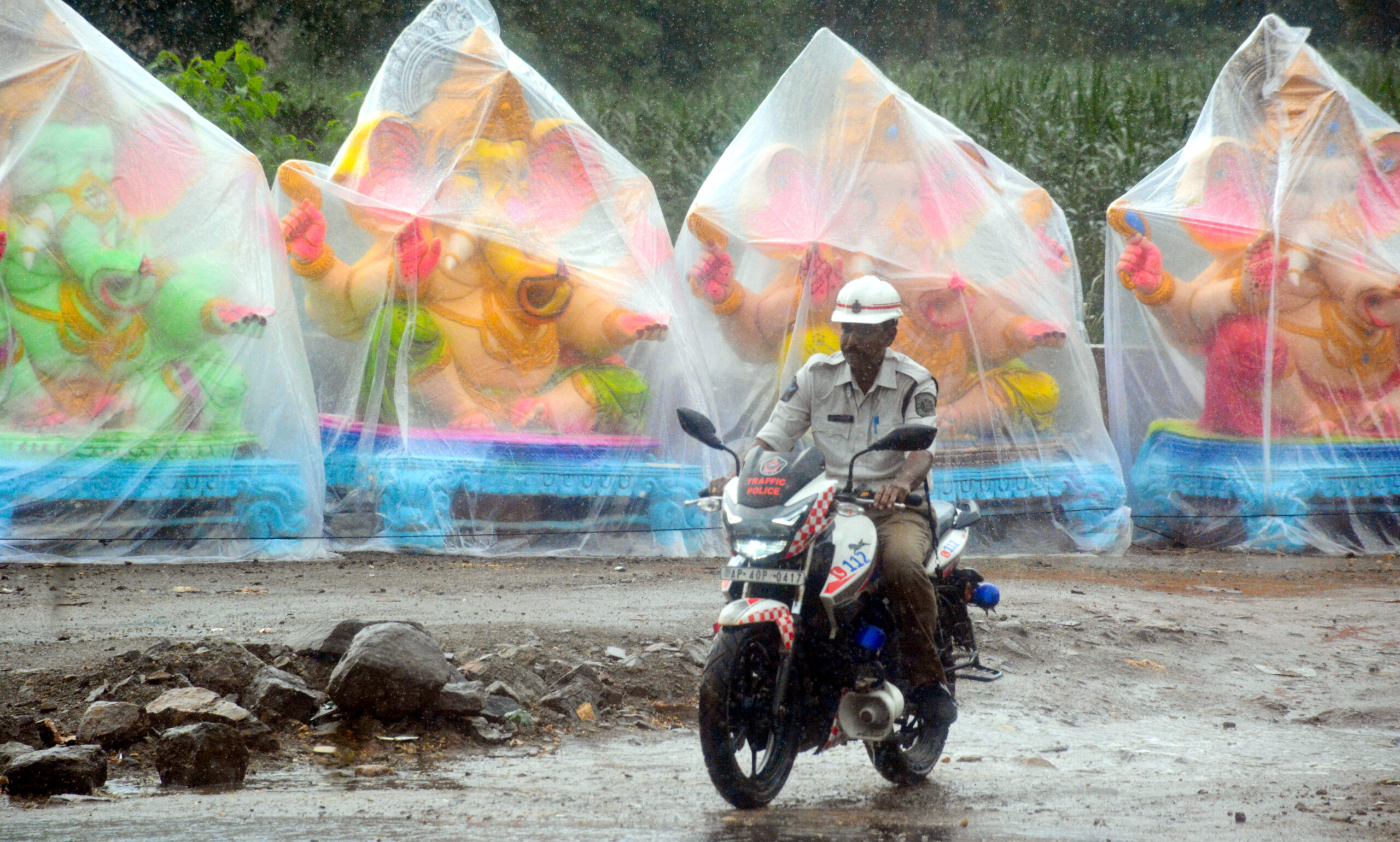 Visakhapatnam: Traffic Policeman Rides Through Sudden Rain #Gallery Visakhapatnam: Traffic Policeman Rides Through Sudden Rain #Gallery