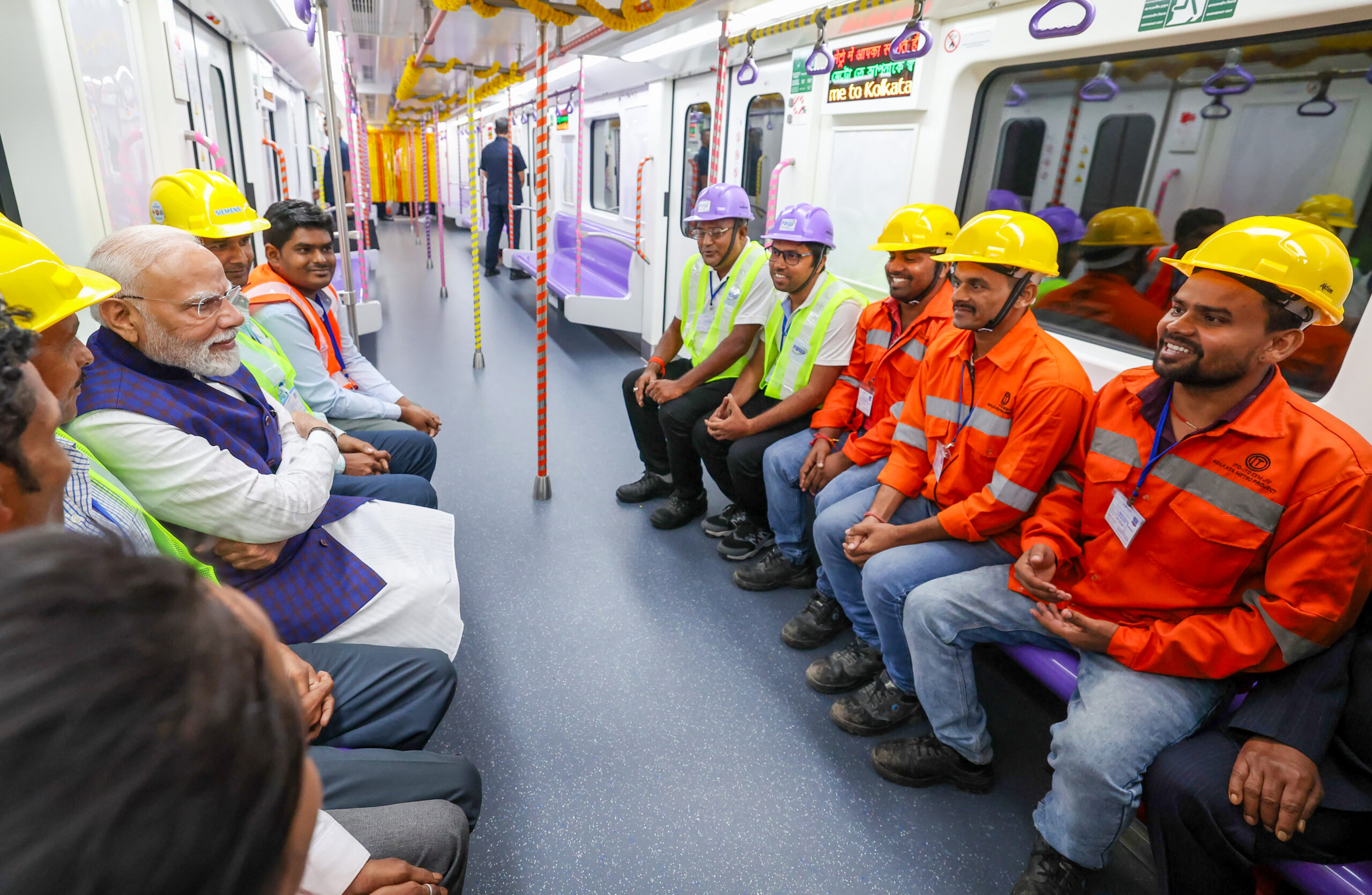 Kolkata: Prime Minister Narendra Modi interacts with construction engineers and workers while travelling on the metro following the flagging off of new metro trains in Kolkata, West Bengal, Friday, August 22, 2025. (Photo: IANS/PMO)
