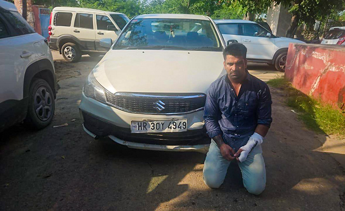 Gurugram: Kalyan Bainsla, the accused in the Golf Course Road accident case, sits in front of the car allegedly used in the incident, in Gurugram, Haryana, on Tuesday, September 15, 2026. Bainsla was arrested by the Gurugram Police Crime Branch from Rajasthan. (Photo: IANS)