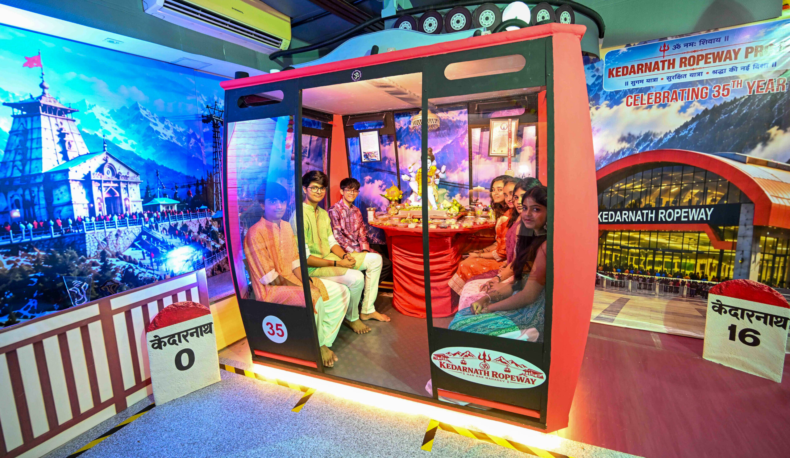 Mumbai: Children sit inside a model cable car displayed as part of a Ganesh decoration showcasing the proposed Kedarnath ropeway project at a residence in Santacruz, Mumbai, on Wednesday, September 16, 2026. (Photo: IANS)