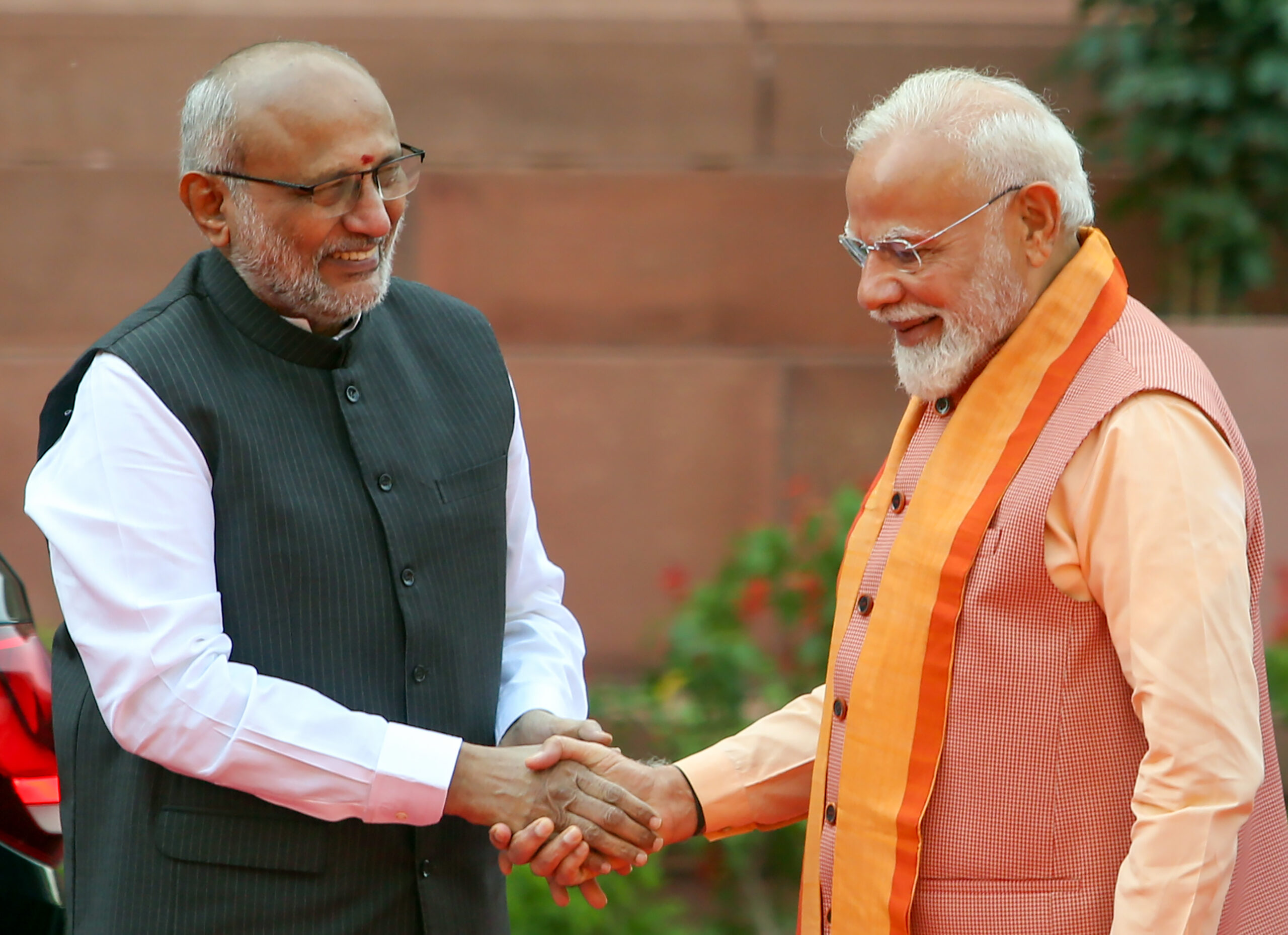 New Delhi: Prime Minister Narendra Modi exchanges greetings with Congress President and Vice-President C. P. Radhakrishnan during the tribute-paying ceremony to Dr. BR Ambedkar on his birth anniversary, observed as "Ambedkar Jayanti," at Prerna Sthal, Samvidhan Sadan, in New Delhi, Tuesday, April 14, 2026. (Photo: IANS/Prem Nath Pandey)