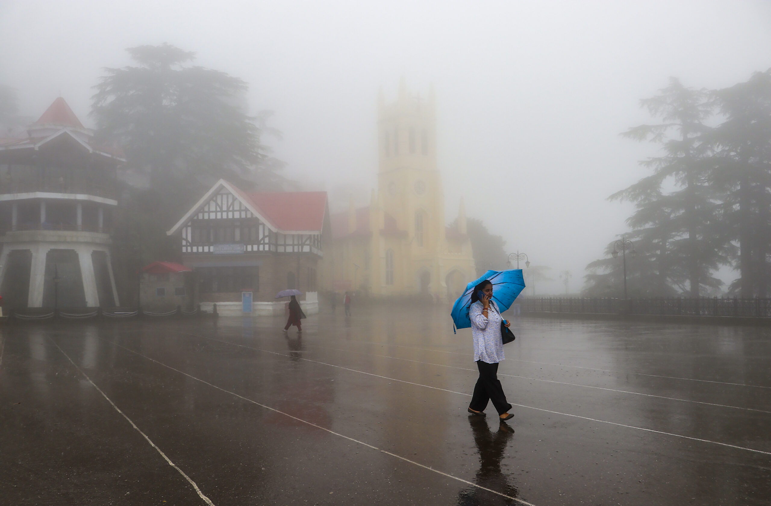 Shimla: People walk with umbrellas amid rain and fog #Gallery Shimla: People walk with umbrellas amid rain and fog #Gallery