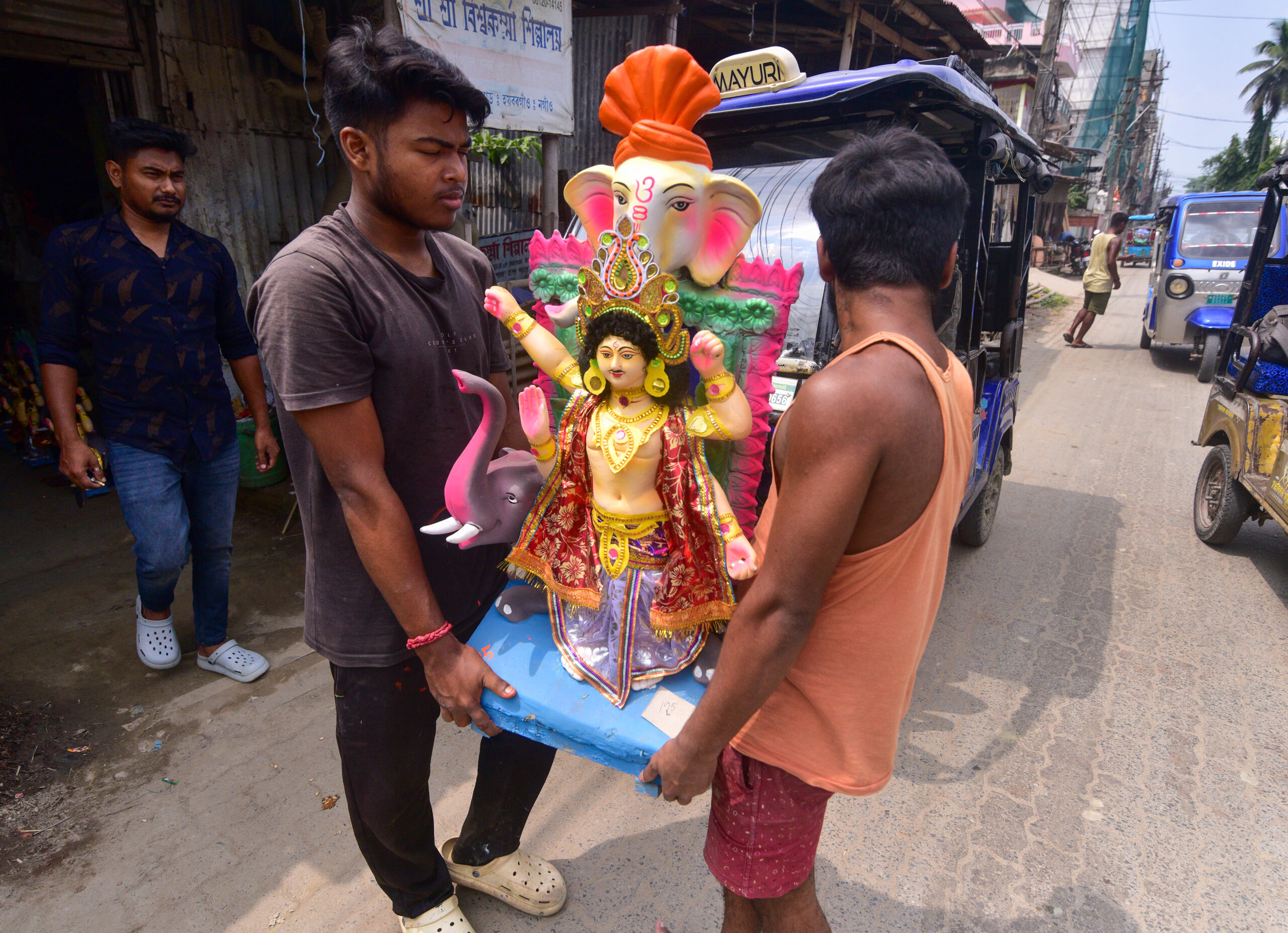 Nagaon: Workers carry Vishwakarma idol ahead of worship day #Gallery Nagaon: Workers carry Vishwakarma idol ahead of worship day #Gallery