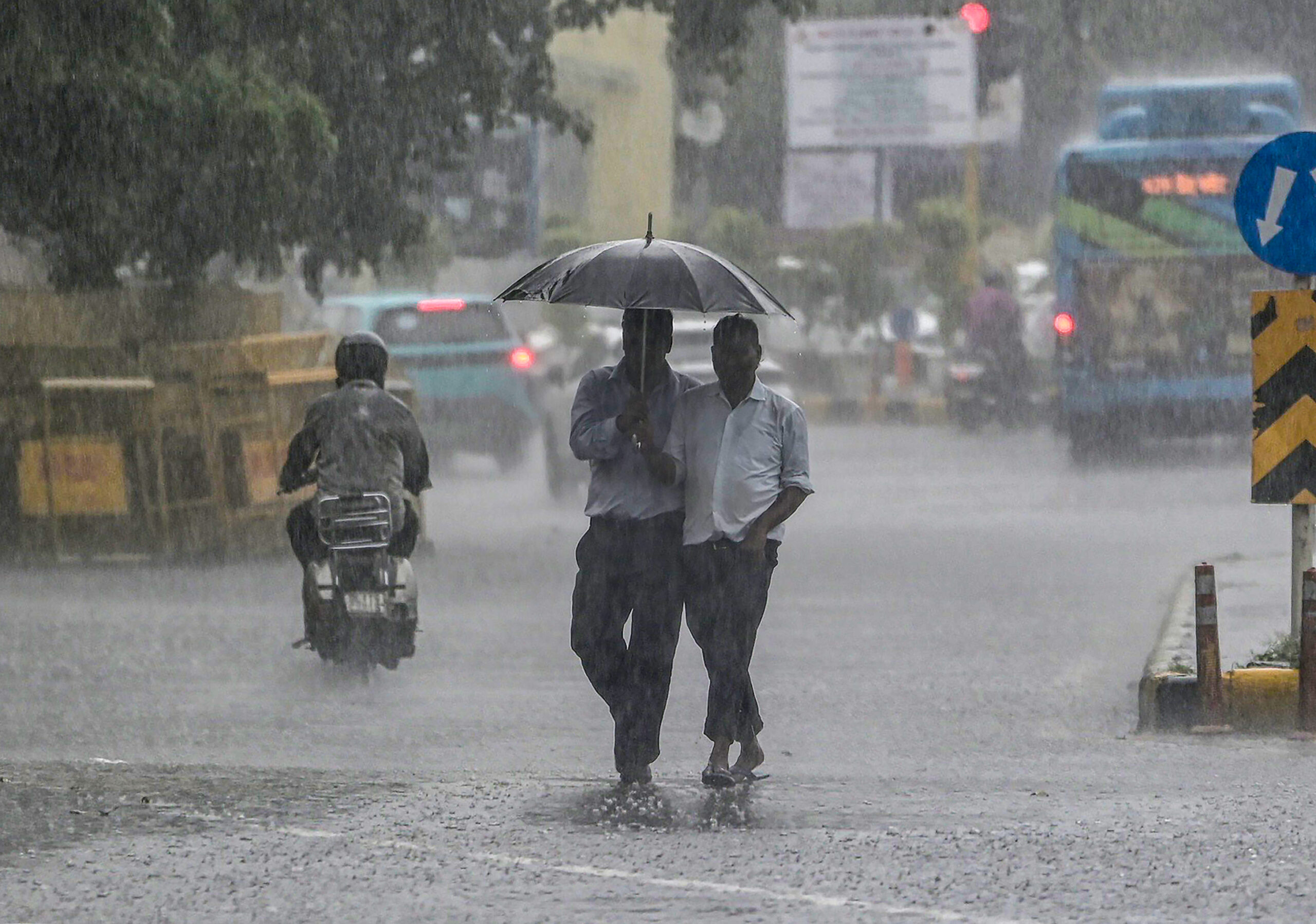 New Delhi: Pedestrians walk along a road under an umbrella amid heavy rain, in New Delhi on Friday, September 11, 2026. (Photo: IANS/Deepak Kumar)