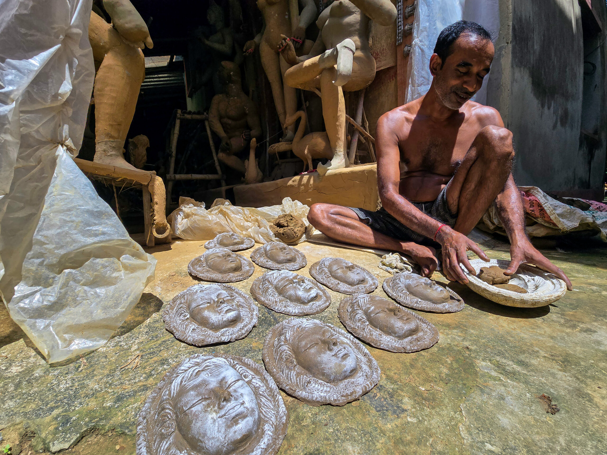 Birbhum: An artisan moulds clay faces for idols at a workshop as preparations for the Durga Puja festival is underway in Suri, Birbhum district of West Bengal, on Monday, September 21, 2026. (Photo: IANS)