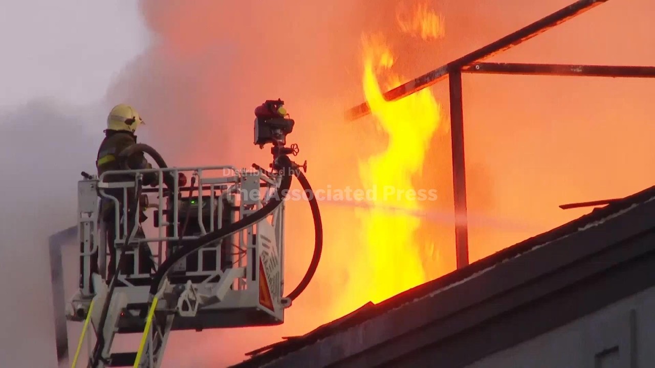 Firefighters tackle the flames after deadly Russian attack in Ukraine (Video)