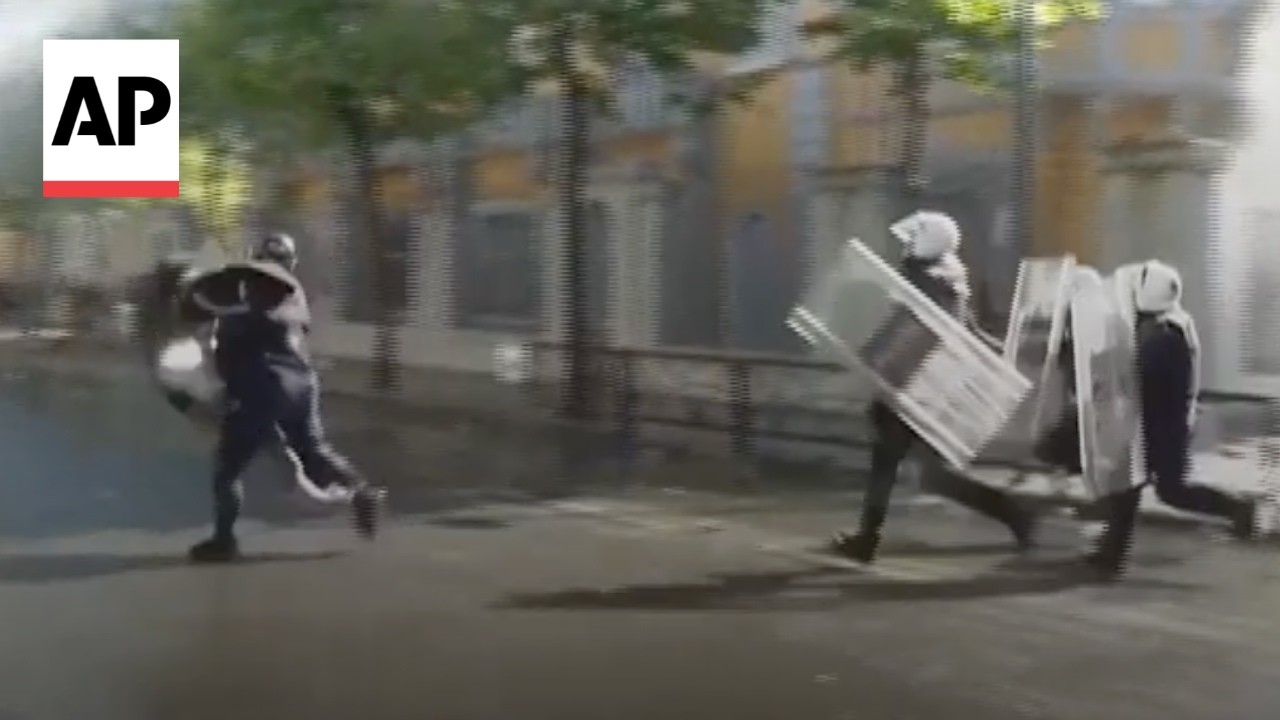 Riot police tackle a protester during clashes in Albania (Video)
