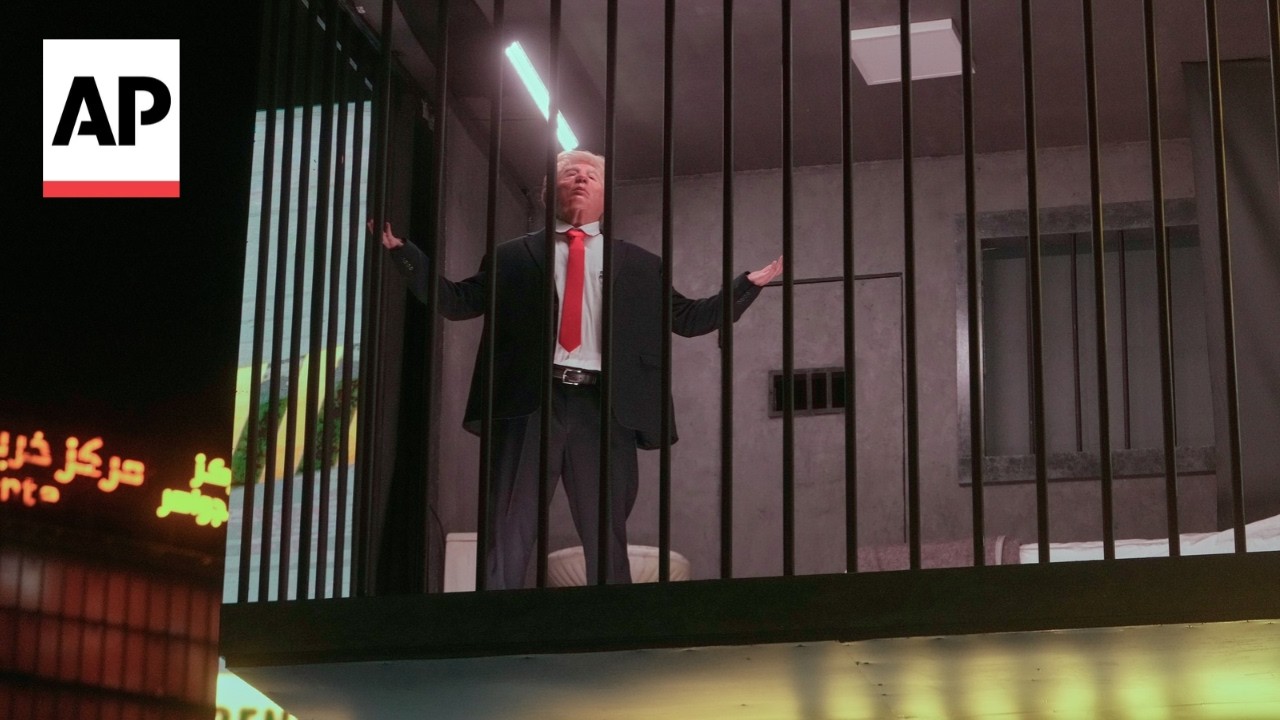A billboard in Iran shows an actor portraying Trump behind bars (Video)
