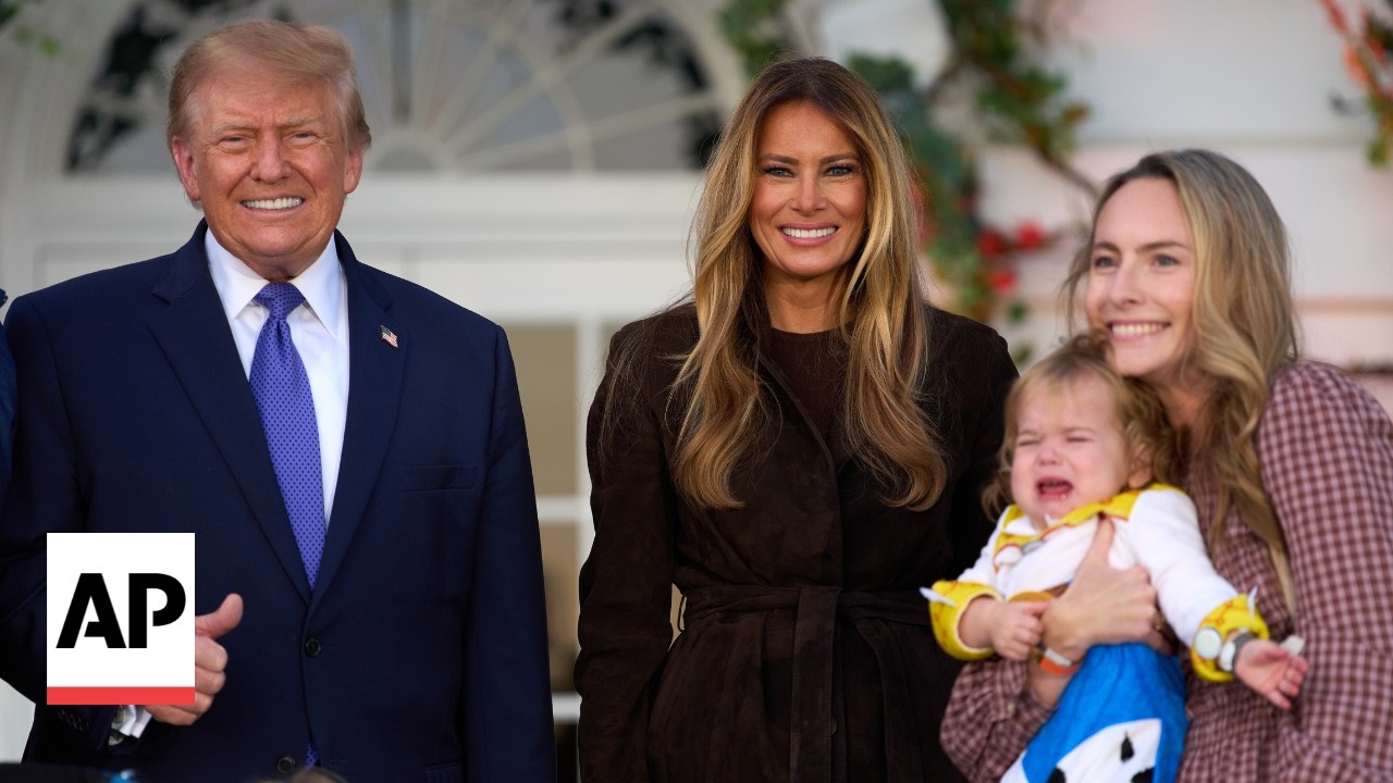 Donald and Melania Trump hand out candy during a Halloween event at the White House (Video)